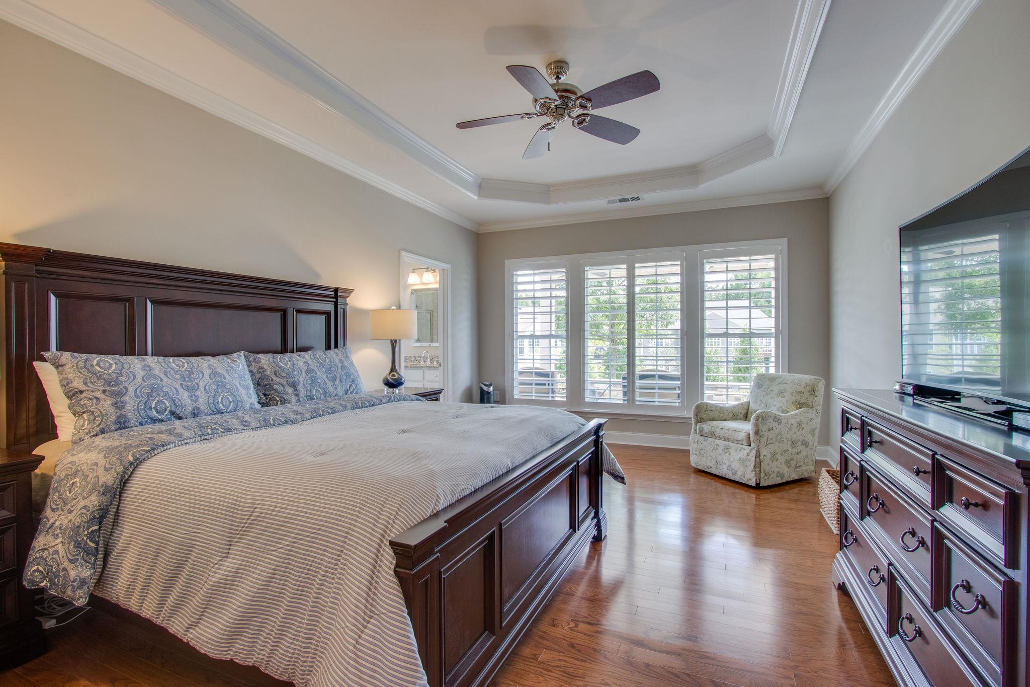 520 Bugler Road Mount Juliet, TN 37122 - Photo 19 of 30 a spacious bedroom with a bed a couch and a chandelier