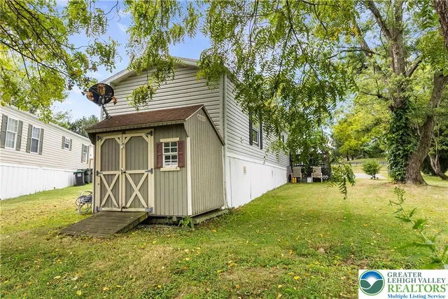 a view of a backyard with a large tree