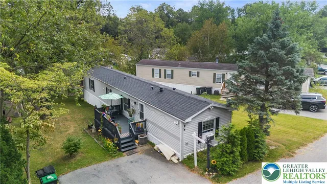 an aerial view of a house with a yard table and chairs