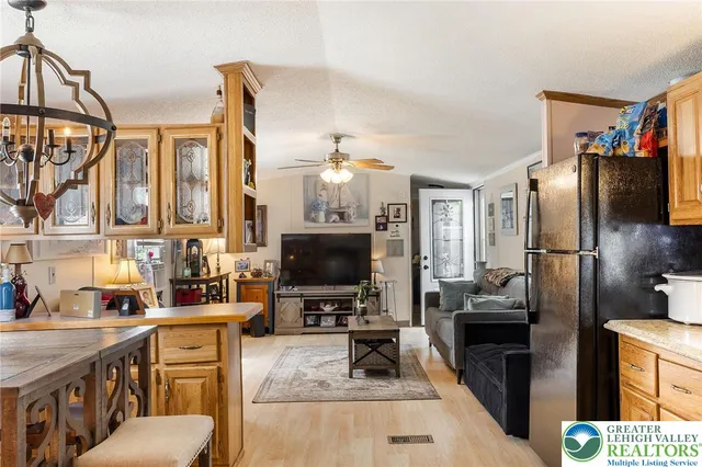 a kitchen with stainless steel appliances a stove refrigerator sink and microwave