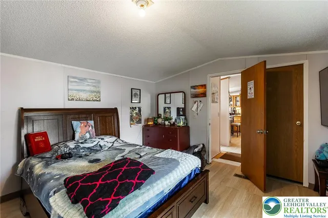 a bedroom with a large bed and a closet