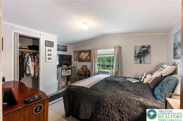 a bedroom with a bed and a tv