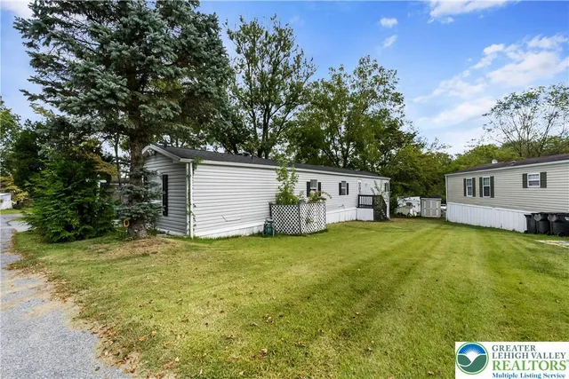 a view of a house with pool and a yard