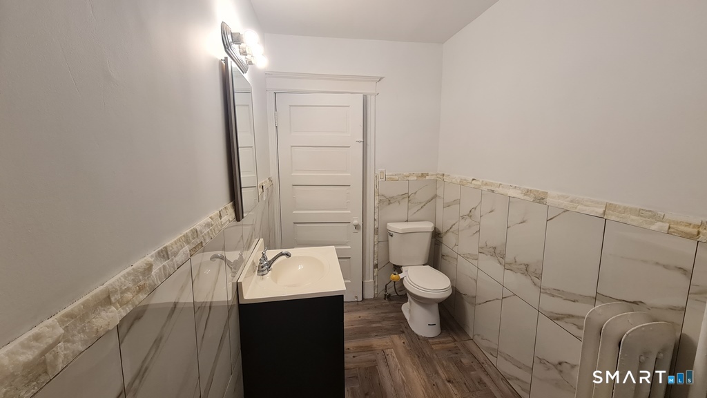 64-66 Ridge Street Manchester, CT 06040 - Photo 8 of 21 a bathroom with a sink and a toilet