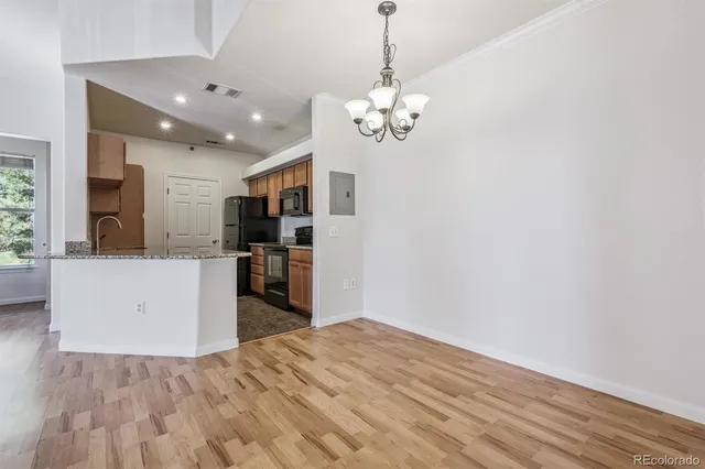 a view of a kitchen with stove and refrigerator