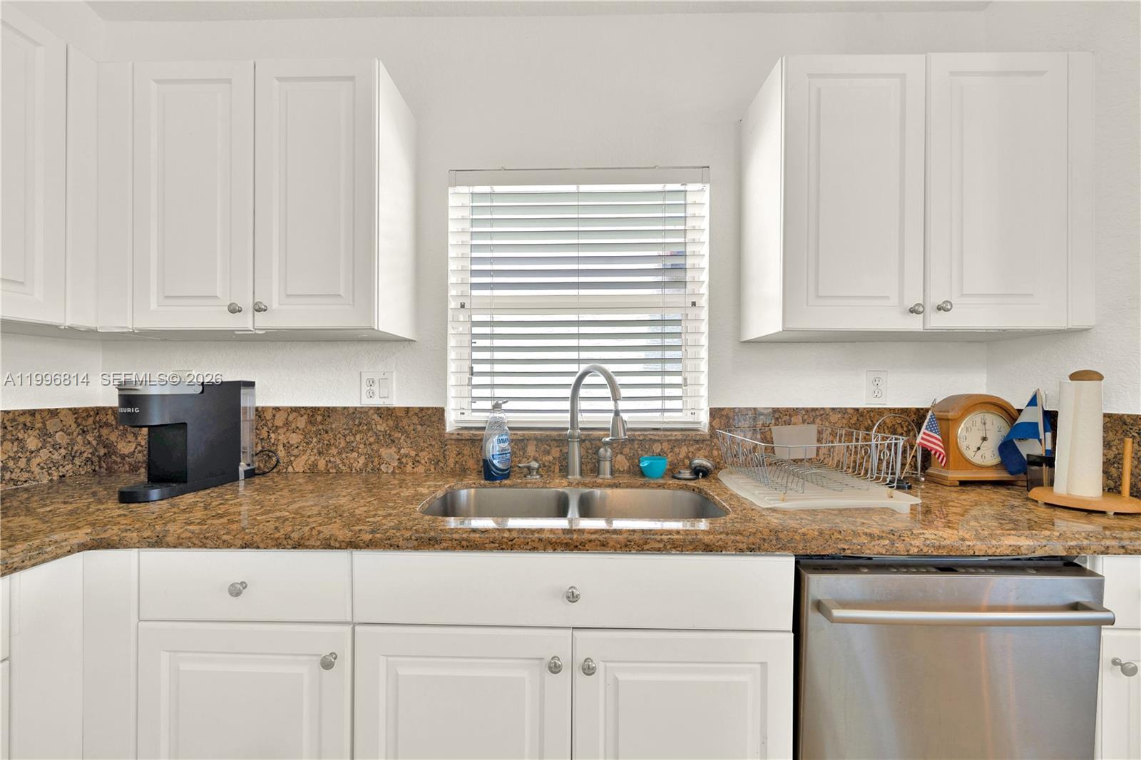 12046 Southwest 133rd Terrace Miami, FL 33186 - Photo 15 of 27 a kitchen with granite countertop white cabinets and a window