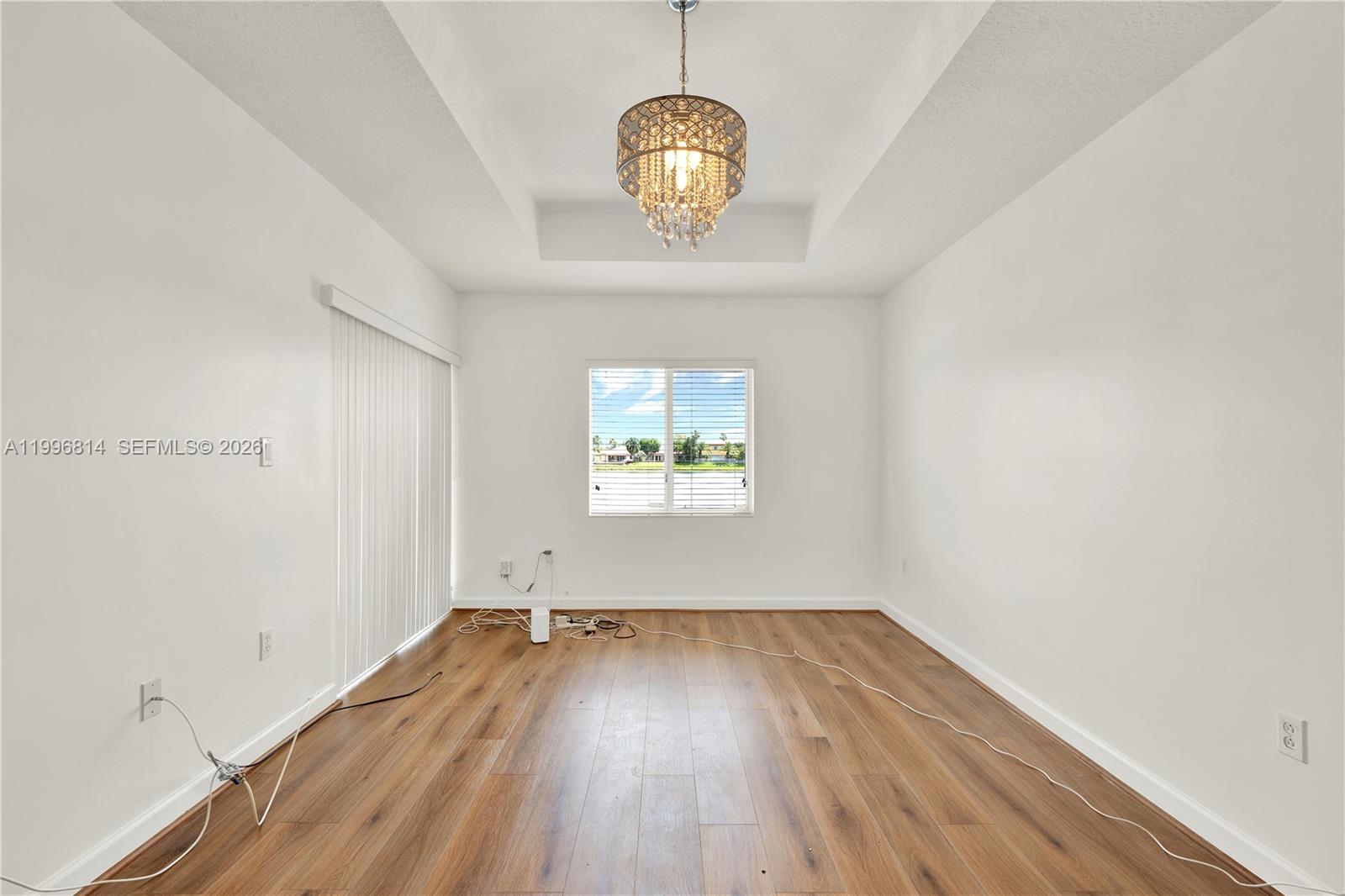 12046 Southwest 133rd Terrace Miami, FL 33186 - Photo 18 of 27 a view of empty room with wooden floor and fan