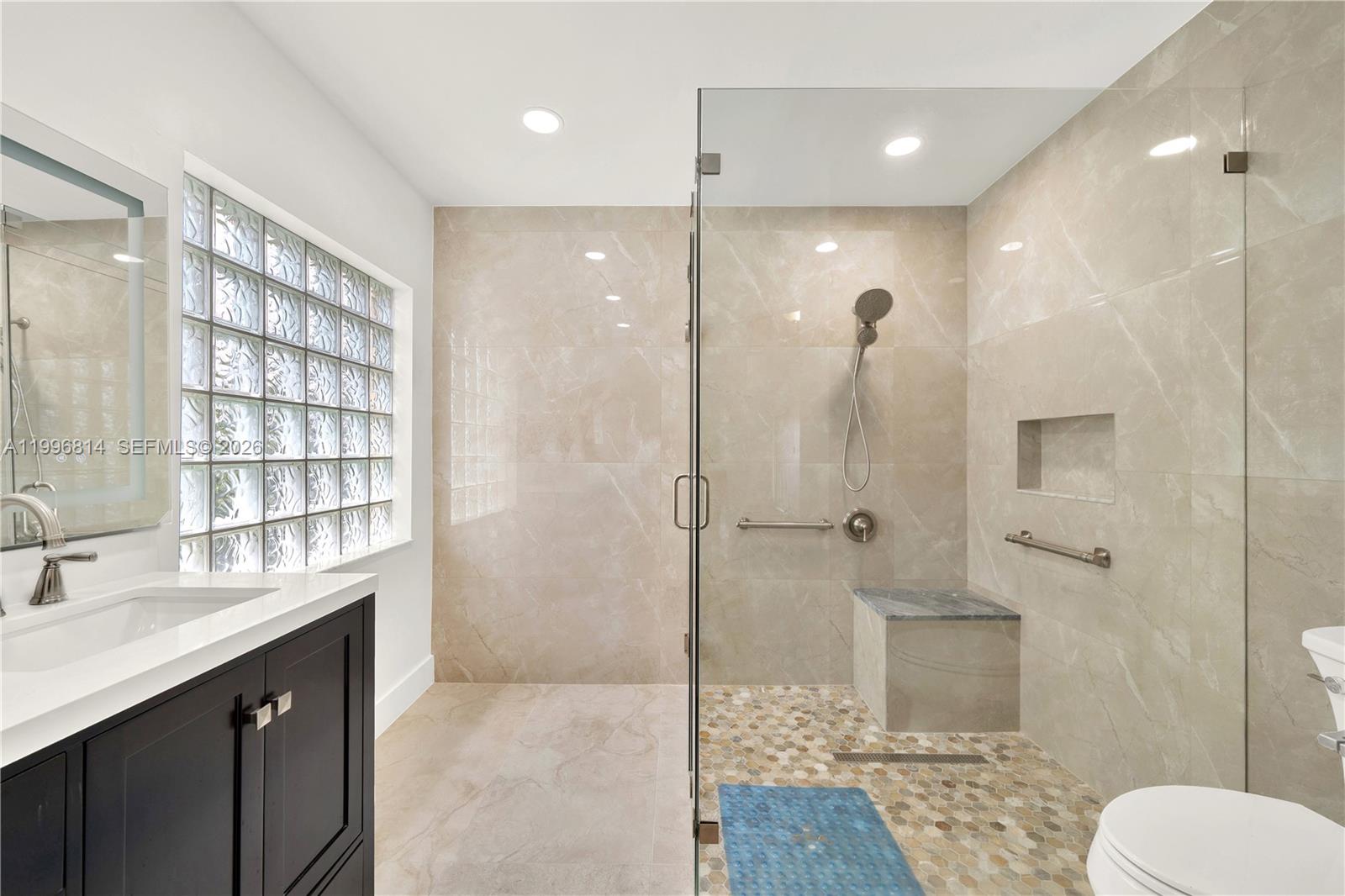 12046 Southwest 133rd Terrace Miami, FL 33186 - Photo 20 of 27 a bathroom with a shower sink and toilet