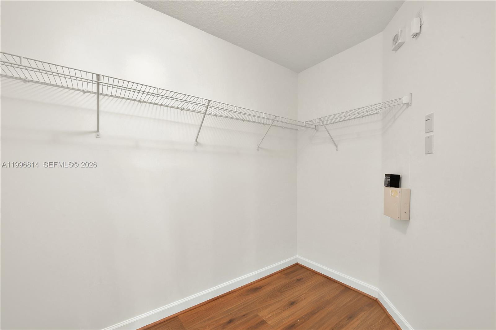 12046 Southwest 133rd Terrace Miami, FL 33186 - Photo 21 of 27 a view of a room with wooden floor