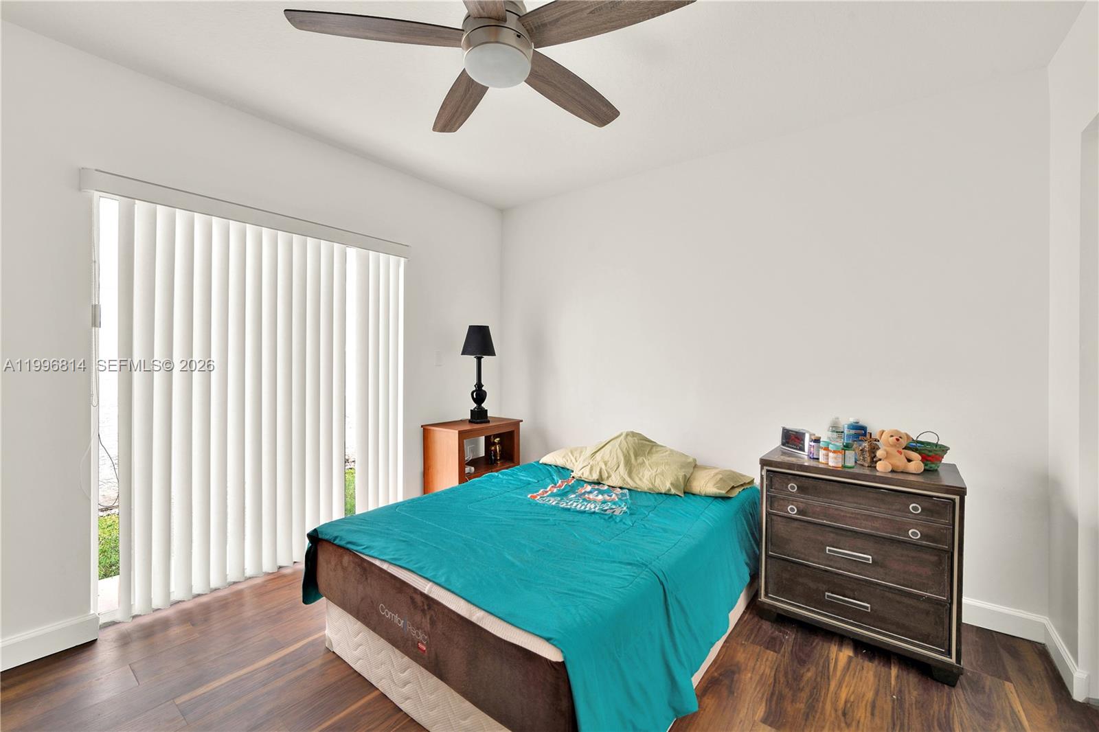 12046 Southwest 133rd Terrace Miami, FL 33186 - Photo 22 of 27 a bedroom with a bed and a window
