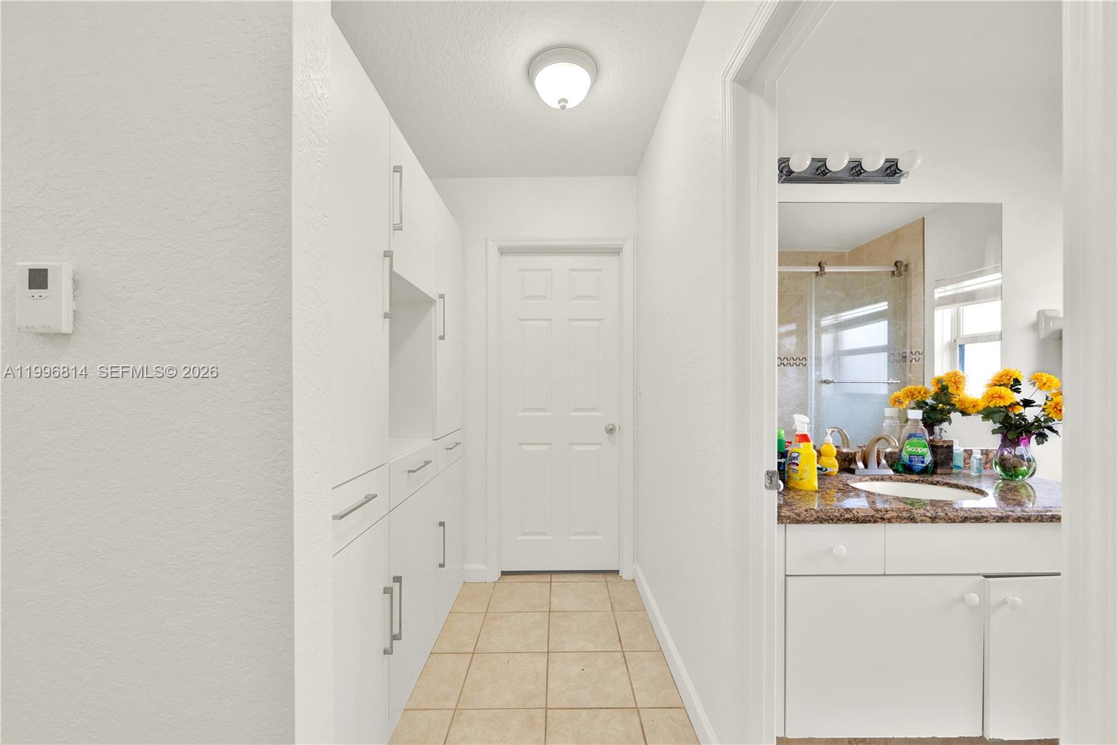 12046 Southwest 133rd Terrace Miami, FL 33186 - Photo 23 of 27 a bathroom with a sink mirror and a shower