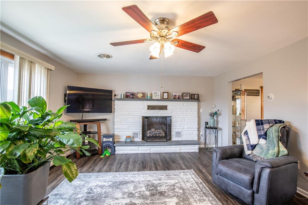 156 Jackson Road New Salem, PA 15468 - Photo 3 of 14 a living room with furniture a flat screen tv and a fireplace