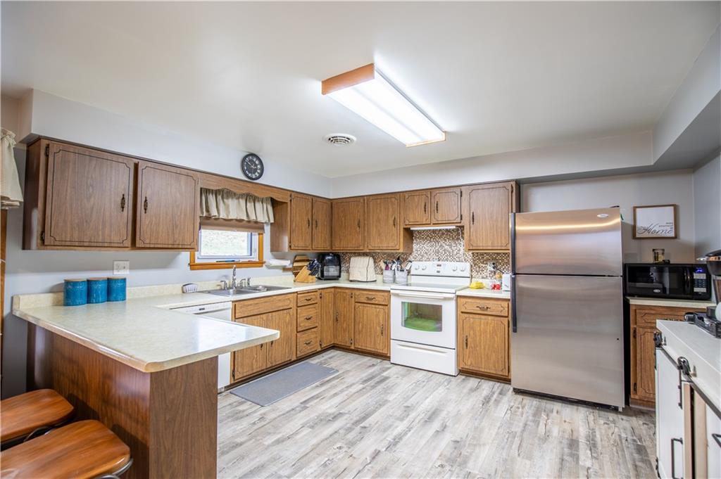 156 Jackson Road New Salem, PA 15468 - Photo 6 of 14 a kitchen with a sink cabinets stainless steel appliances and a window