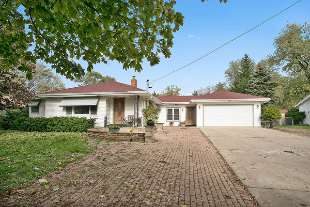 21W502 Army Trail Road Addison, IL 60101 - Photo 1 of 10 a front view of a house with a garden and trees
