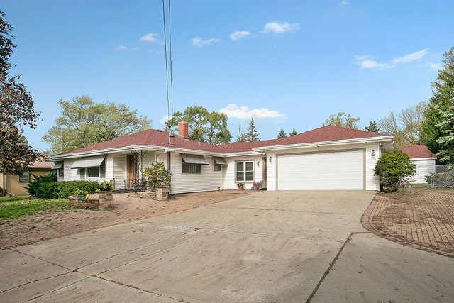 21W502 Army Trail Road Addison, IL 60101 - Photo 2 of 10 a front view of a house with a garden and patio