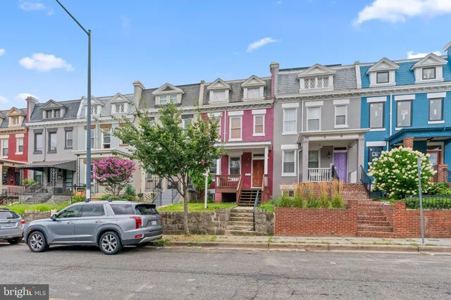 a front view of a brick house with a yard