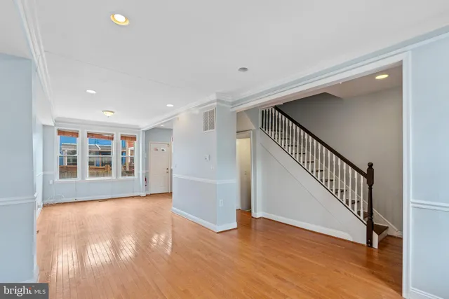 a kitchen with granite countertop wooden cabinets stainless steel appliances and a window