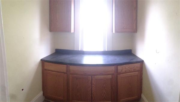151-153 Draper Street Springfield, MA 01108 - Photo 12 of 13 a room with a lamp and a window