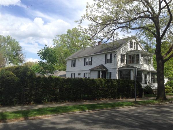 151-153 Draper Street Springfield, MA 01108 - Photo 2 of 13 a front view of a house with a garden