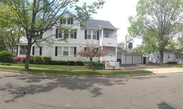 151-153 Draper Street Springfield, MA 01108 - Photo 4 of 13 a front view of house with small yard and large trees