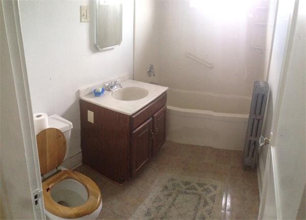 151-153 Draper Street Springfield, MA 01108 - Photo 10 of 13 a bathroom with a sink toilet and a mirror