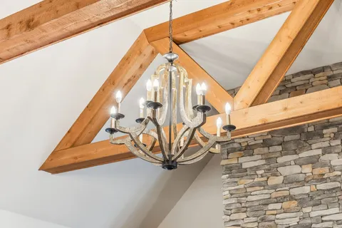 a view of a dining room with furniture a fireplace and wooden floor