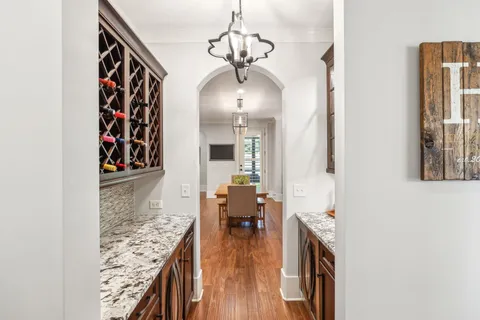 a spacious bedroom with a bed a ceiling fan and a dresser