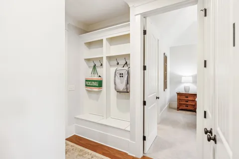 an aerial view of residential houses with outdoor space and trees