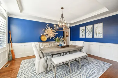 a view of a dining room with furniture and chandelier