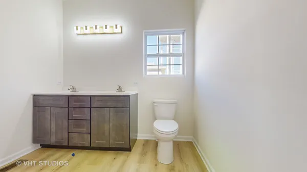 a bathroom with a sink a toilet and vanity