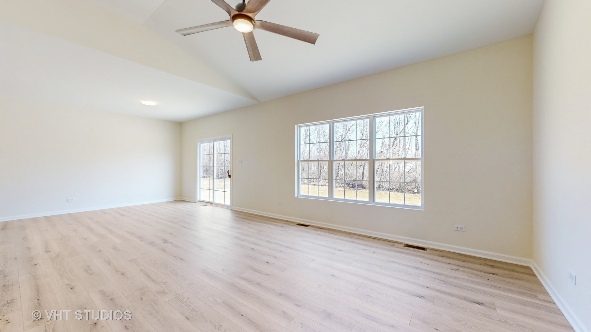 593 Farm Street Crete, IL 60417 - Photo 4 of 28 an empty room with wooden floor fan and windows