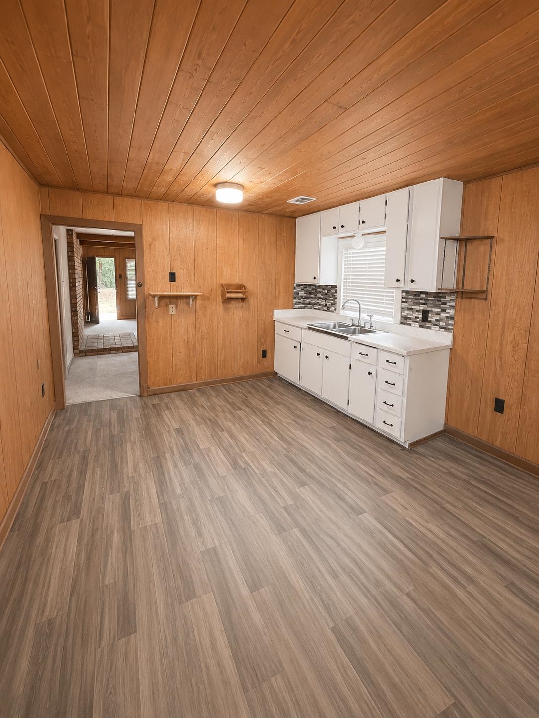 6760 Locke Road Millington, TN 38053 - Photo 14 of 31 a large kitchen with wooden floors and white appliances