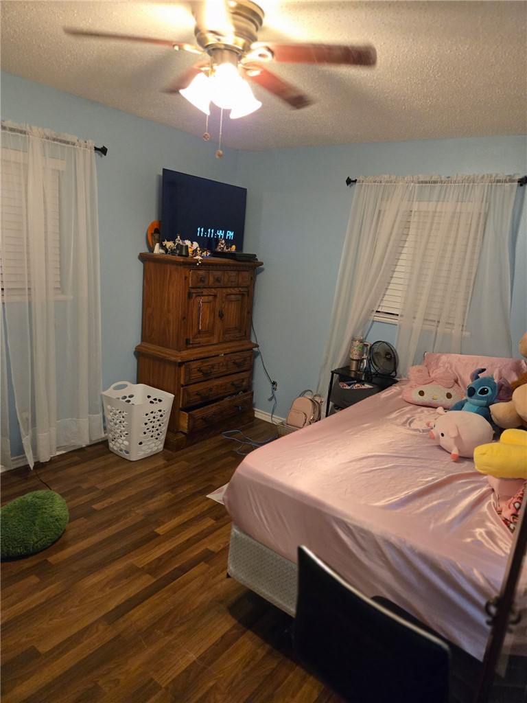 24772 County Road 360 Mathis, TX 78368 - Photo 14 of 30 a bedroom with a bed and a chandelier