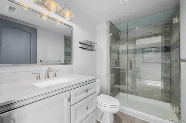 a bathroom with a sink toilet and shower