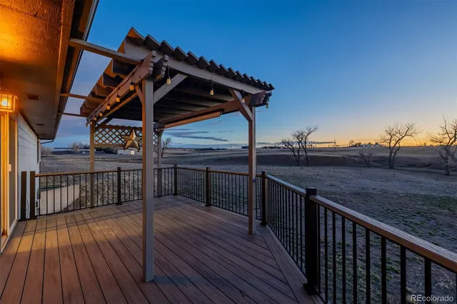a view of deck with wooden floor and fence