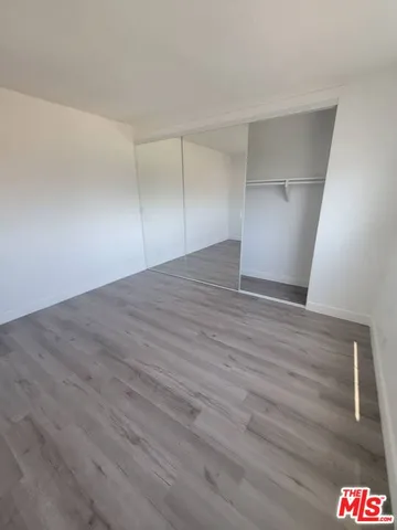 a view of an empty room and wooden floor