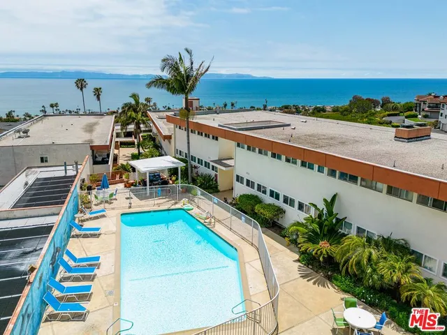 a view of a swimming pool with an outdoor seating