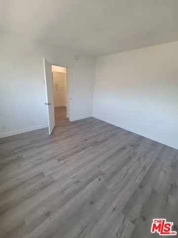 a view of an empty room and wooden floor