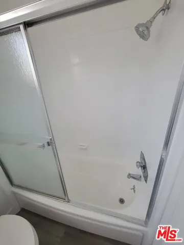 a bathroom with a shower and toilet