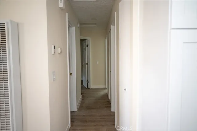 a view of a hallway with wooden floor