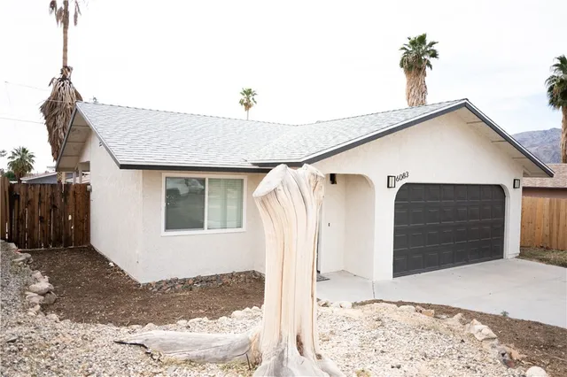 a view of a house with a snow on the road