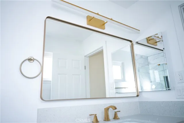 a bathroom with a mirror and a shower