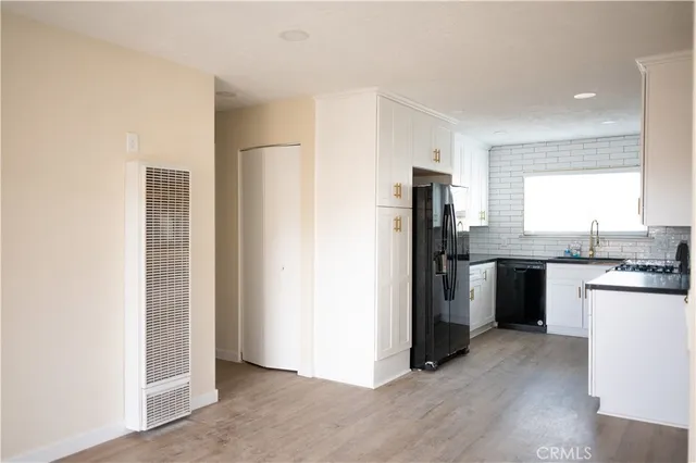 a kitchen with a refrigerator and a stove top oven
