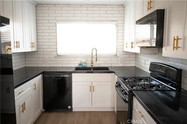 a kitchen with a sink stove top oven and cabinets