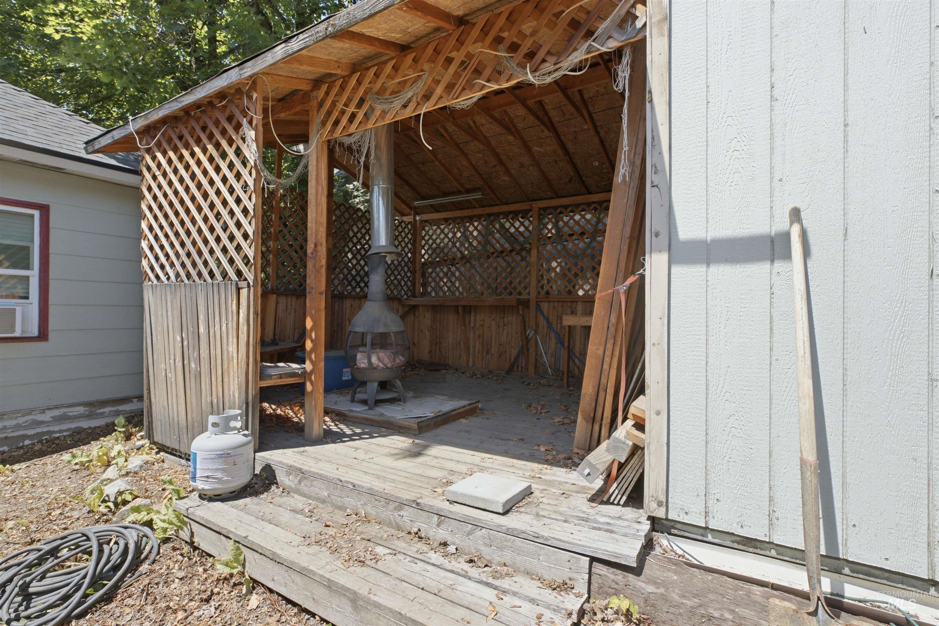 735 Oak Street Potlatch, ID 83855 - Photo 19 of 30 Wooden gazebo structure featuring lattice walls and a wooden floor, with a chiminea present