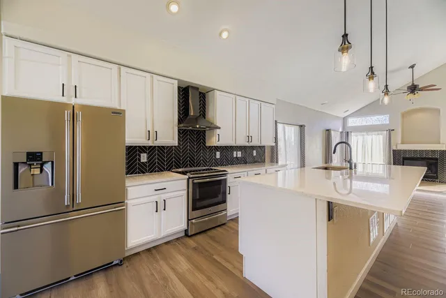 a kitchen with stainless steel appliances a refrigerator sink and cabinets