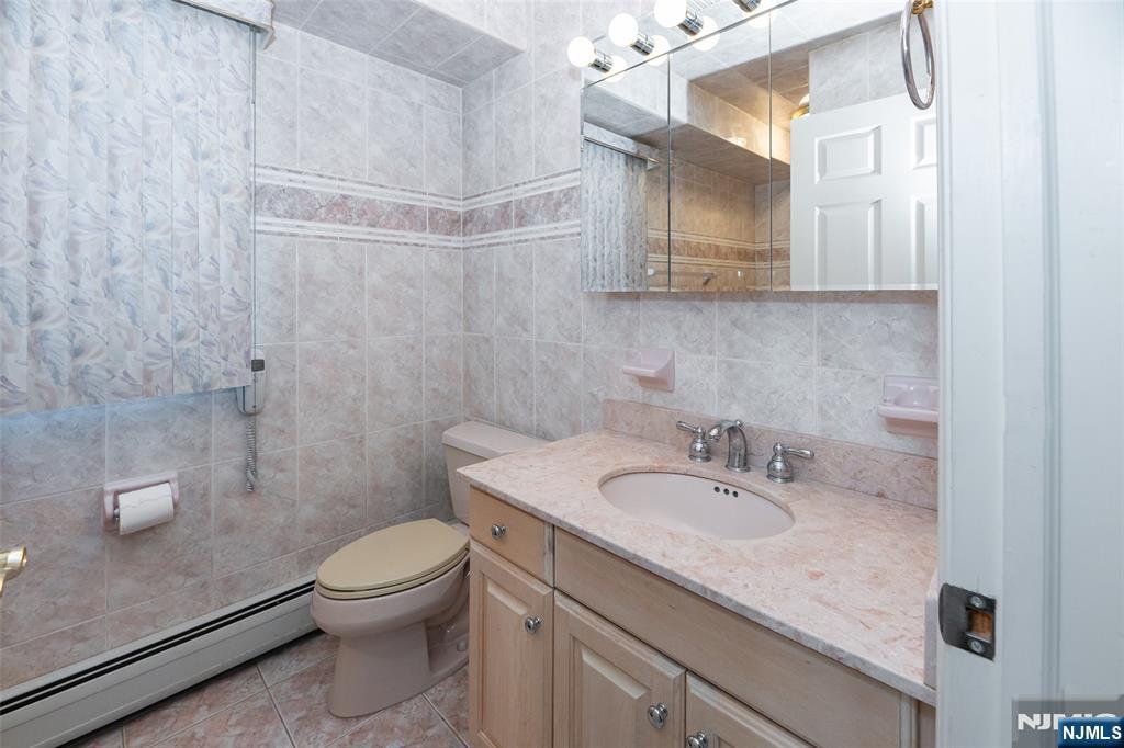499 Morse Avenue Ridgefield, NJ 07657 - Photo 11 of 45 a bathroom with a sink a toilet and shower