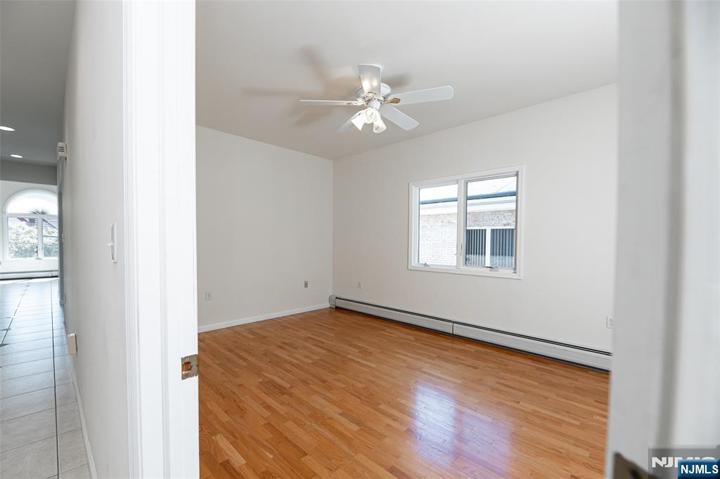 499 Morse Avenue Ridgefield, NJ 07657 - Photo 26 of 45 wooden floor in an empty room with a window