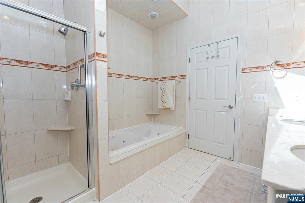 499 Morse Avenue Ridgefield, NJ 07657 - Photo 33 of 45 a bathroom with a bathtub and a shower