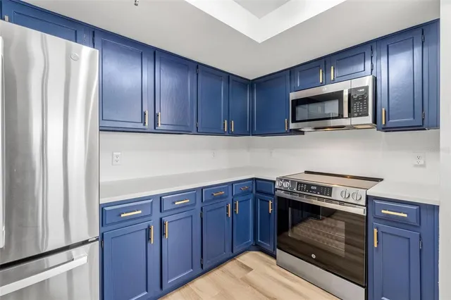 a kitchen with wooden cabinets stainless steel appliances and wooden cabinets